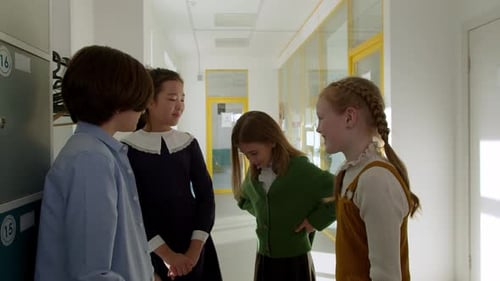 Elementary School Class Children Communicate with the Teacher Answering Question