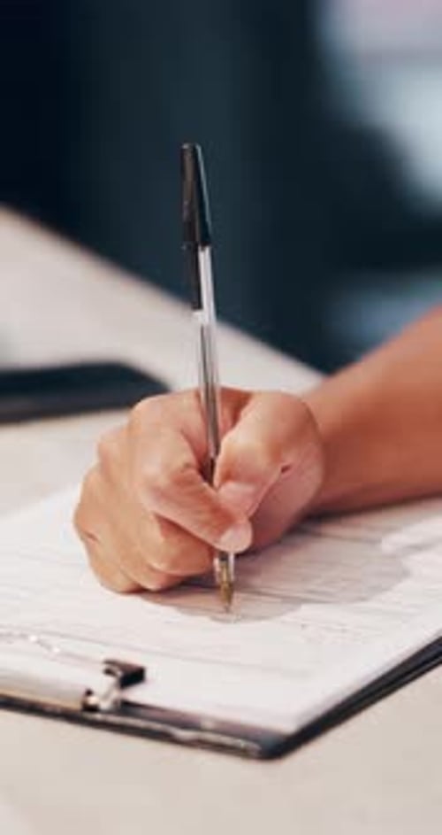 Hand, writing and clipboard in office with document, health insurance application