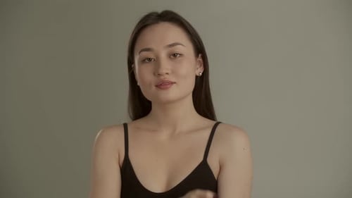 Woman Doing Face Massage in Black Tank Top