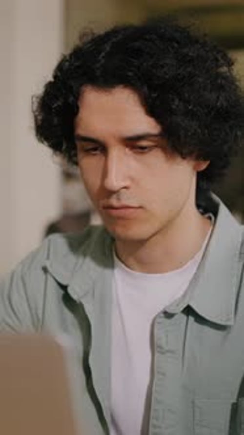 Man Typing on Laptop Indoors, Close Up