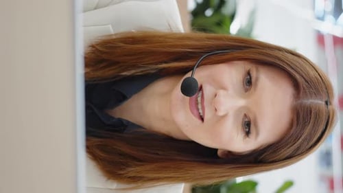 Vertical Screen Operator of Call Center Using Headset and Talking to Customer