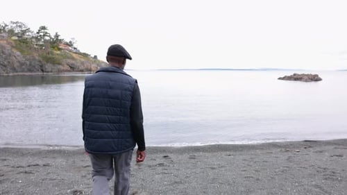 Senior Man Walking on Beach Toward Ocean Skimming Stones 6569 Years