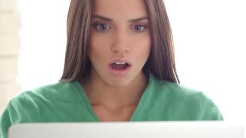 Surprised Woman Looking at a Computer Screen