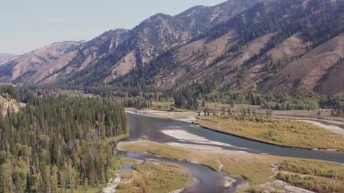 Aerial drone shot of Snake River passing over sandbars and rocky riverbanks. Forward tracking and do