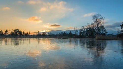 Time lapse with reflection on an ice surface while sunset