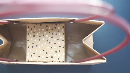 Top View of Gift Box in a Packet on Table