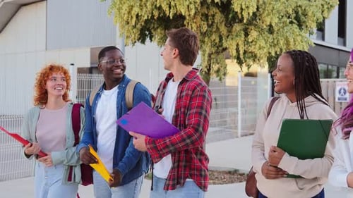 Diverse Group of Five Young Multiracial Students Walking Confidently Toward Their University Campus
