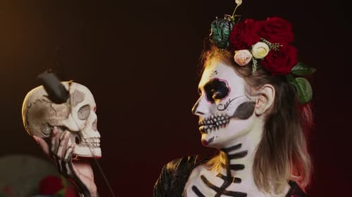 Woman with Day of the Dead Makeup Posing with Skull