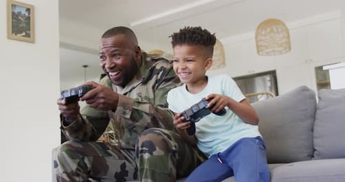 Happy Man and Child Playing Video Games Together