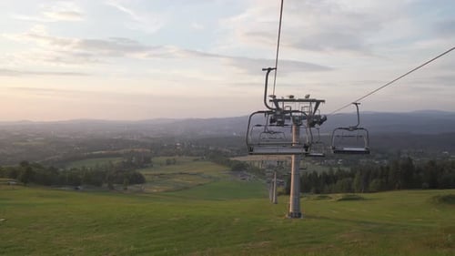 Summer panorama with ski lift with no people, panning left