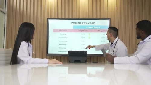 Medical Team Analyzes Patient Data in Conference Room