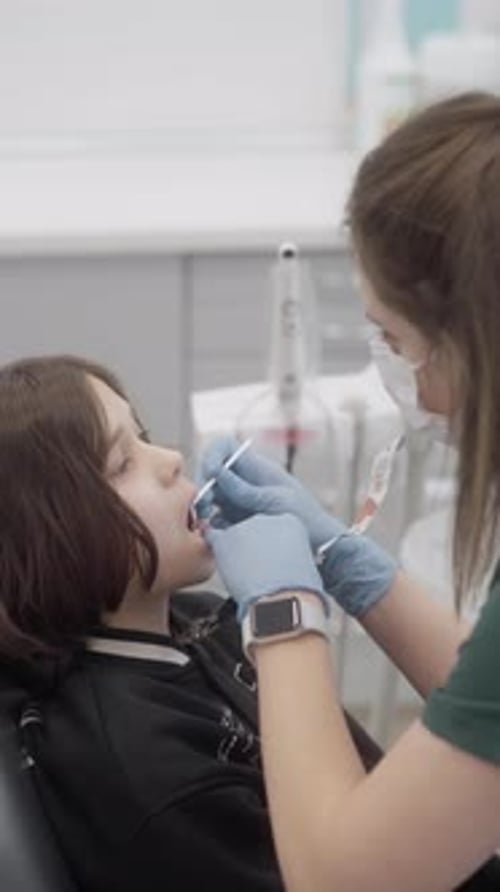 Young Patient Getting Dental Exam at Dentist Office