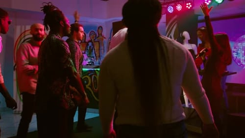Enthusiastic Young Adults Dancing at Lively Nightclub Party