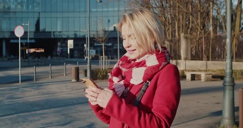 Woman Using Smartphone in Urban Setting