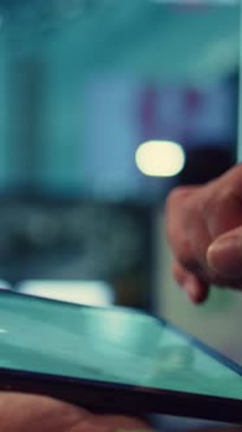 Hands Using Digital Tablet at Night