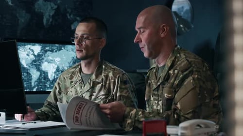 Commanders Reviewing Documents Using Computer in Office