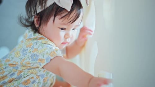 Cute Baby Plays with Abacus in Playpen