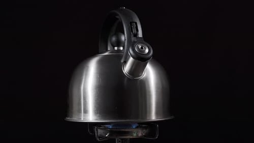 Silver Kettle on Gas Stove Heating Water