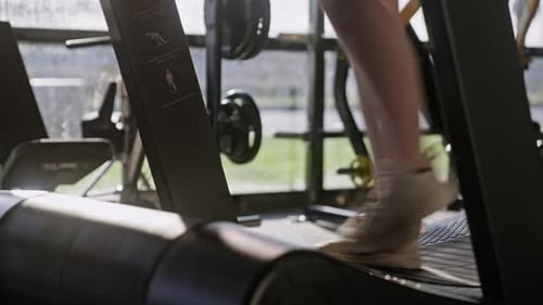 Woman Walking On Treadmill In Gym