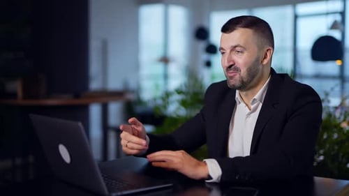 Adult Man Talking on Video Call in Office