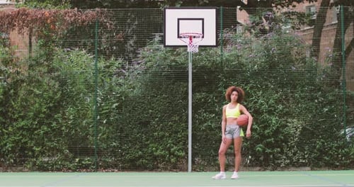 Portrait young adult female on a basketball court