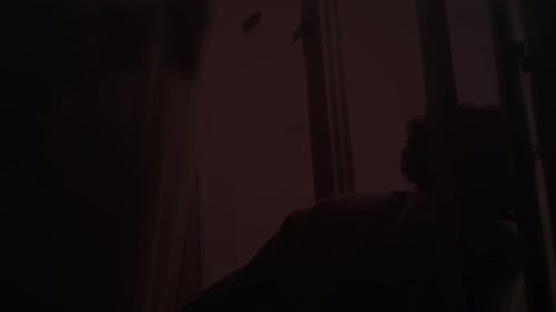 Man Closing Window During Intense Red Pulsing Light Emergency