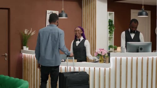Hotel Guest Checking in at Reception Desk