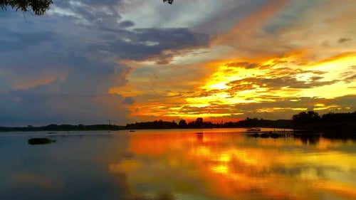 The beautiful sunset over the calm waters of the lake makes for a perfect view