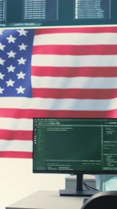 American Flag Behind Computer Monitors