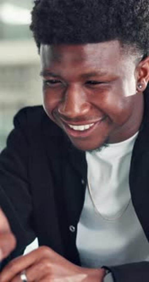 Creative, black man and reading on laptop in office for research, copywriting and editor feedback