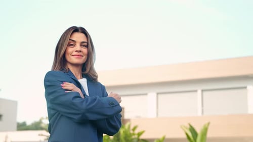 Businesswoman Smiling Outside Modern Office Building
