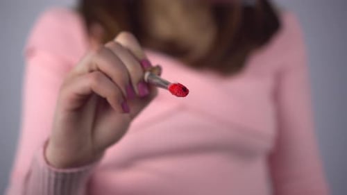 A Young Woman Draws a Heart on the Glass