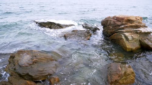 Slow motion scenic landscape of nature sea wave coast to beach with stone and rock for summer vacati