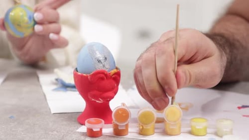 Closeup Shot of Adult Male Parent Painting Easter Egg