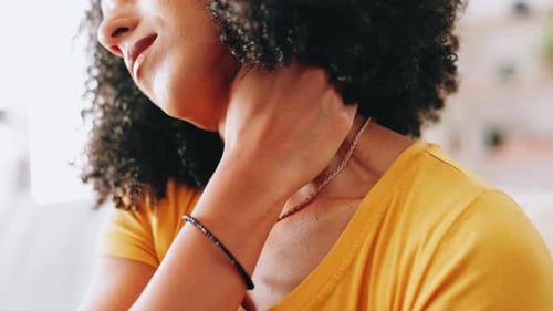 Woman Massages Neck to Relieve Muscle Tension