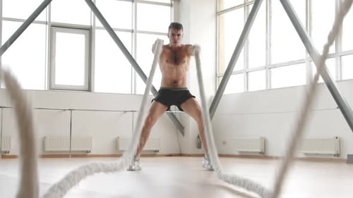 Muscular Man Working Out with Battle Ropes