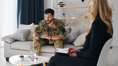 Soldier Talks to Therapist in Bright Living Room