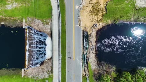 Aerial View of Damaged Road Bridge Over River After Flood Water Washed Away Asphalt