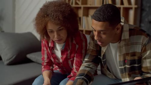 Young Couple Using Digital Tablet at Home