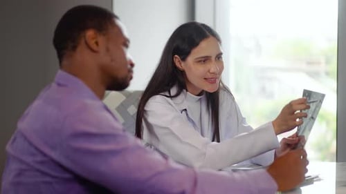 female doctor explains brain X-ray results to a male patient during a medical consultation in clinic