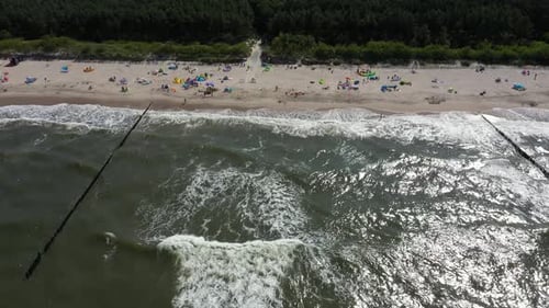 Baltic Sea coast beach Hel aerial drone top view 4K UHD video. People on the beach. Aerial View