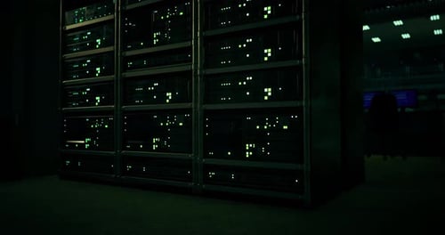 Detailed View of Illuminated Server Rack in Dark Tech Environment