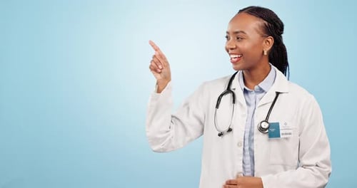 Happy black woman, doctor and pointing in advertising or marketing against a blue studio background