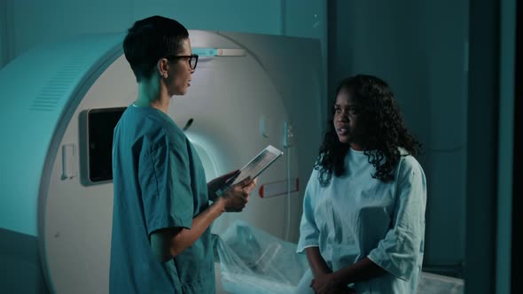 Female Radiographer Reassuring Young Woman before Undergoing Brain ...