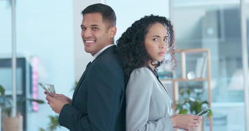 Business People Counting Money in Office