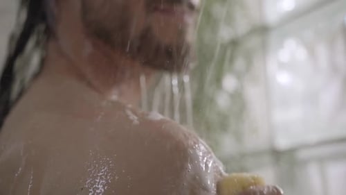 Man Showering with Sponge in Bathroom