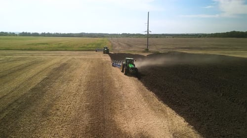 Tractors plowing the field in Ukraine