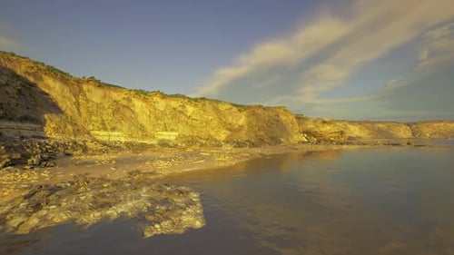 Golden Hour Coastal Landscape with Cliffs and Beach