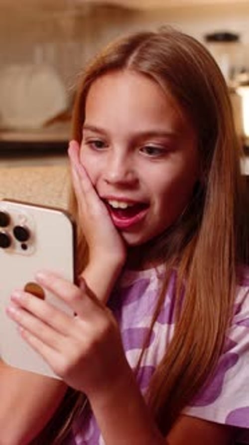 Excited Girl Reacts to Phone News Indoors