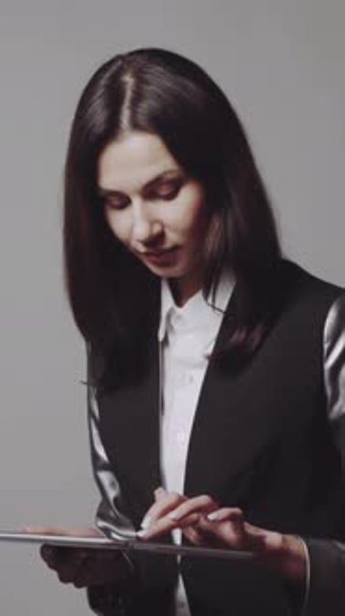 Woman using tablet. Business woman holding and using tablet in studio